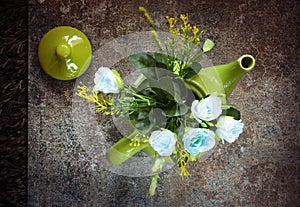 Decorative old teapot with a bouquet of roses