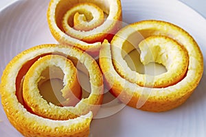 Decorative orange peels on white plate