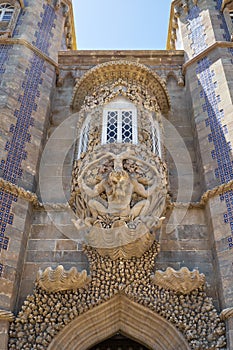 The decorative oriel window with the Triton sculpture over gateway of Creation. Sintra. Portugal