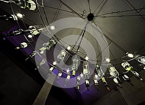 a decorative, original ceiling lightnig with wine bottles