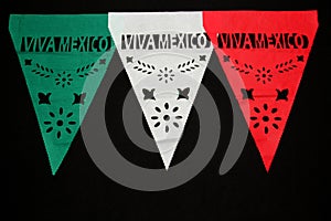Decorative paper pennants for a Mexican party that say `Viva MÃÂ©xico` with the colors of the flag: green, white and red photo