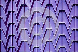 Decorative parts of metal gates. Metal purple fence. Texture of