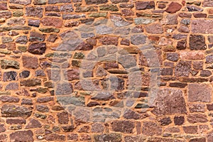 Decorative Pattern of ancient red stone wall background, texture. random size rock wall