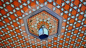 Decorative pattern-ornament on the ceiling and the lamp in the Khan`s Palace in Bakhchisarai photo