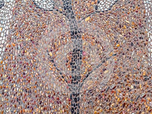 Decorative pattern on the sidewalk paved with small beach pebbles