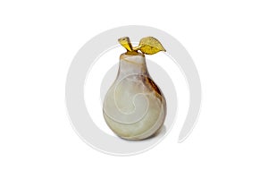 Decorative pear made of natural stone with a gilded twig on a white background close-up