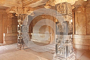 Decorative pillars from black basalt in mandappa or Hall. Hazara Rama Temple Hampi, Karnataka. Stone carving ancient. Indian God