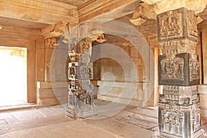 Decorative pillars from black basalt in mandappa or Hall. Hazara Rama Temple Hampi, Karnataka. Stone carving ancient. Indian God