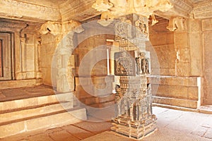 Decorative pillars from black basalt in mandappa or Hall. Hazara Rama Temple Hampi, Karnataka. Stone carving ancient. Indian God