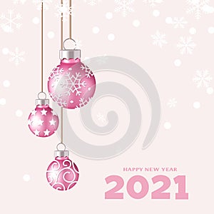Decorative pink Christmas balls with rope and happy New Year 2021 text on pink background with snowflakes.