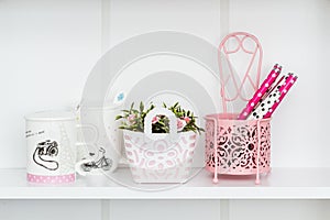 Decorative Pink Objects on White Shelf