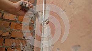 Decorative plaster coating. Man does ragged texture on the wall using a spatula. plaster application on the wall