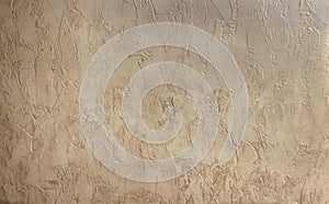 Decorative plaster wallpaper on a wall in beige