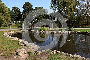 Decorative pond and small bridge with many padlocks in the City park Bastion Hill in Riga center