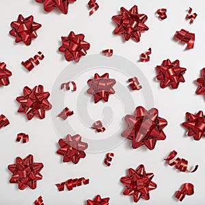 Decorative red bows and serpentine on a white background