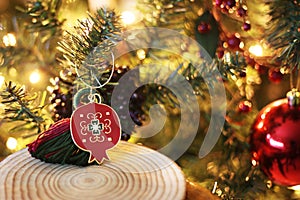 Decorative red Christmas pomegranate in front of the Christmas tree