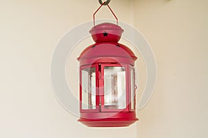 Decorative red metal lantern on light background