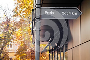 A decorative road sign with directions and distances to the world`s largest cities near the cafe