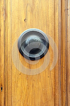 Decorative round door knocker on a wooded door