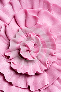 Decorative ruffled pink icing on a cake