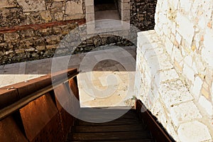 Decorative rusty steel stair along white stone wall. architecture and design concept