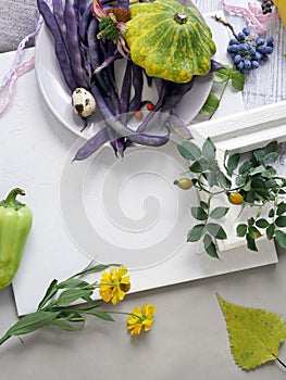 Decorative seasonal still life of quail eggs, fruits, berries, vegetables, spices on a light background