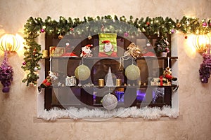 Decorative shelf with Christmas decorations on the wall in the l
