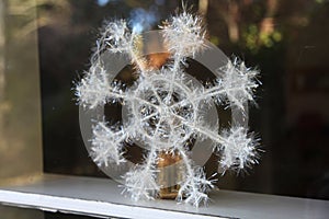 Decorative snowflake by the window