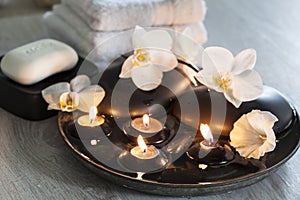Decorative spa still life with soap, towels, orchid flowers and candles