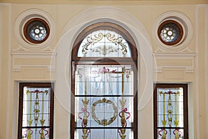decorative stained glass with vegetable  floral ornaments in the window. Beautiful stained glass window with symbols love.