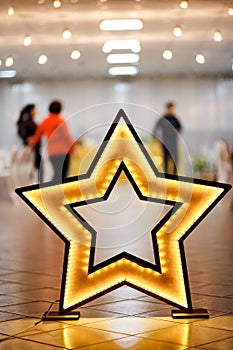 Decorative star made of wood with LED backlight on floor