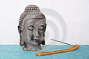 A decorative statue of Buddha, Buddha on the background of incense, Siddhartha Gautama has reached enlightenment. Symbol