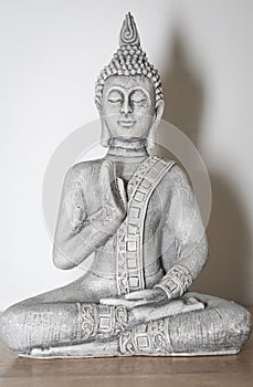 Zen Decor: Wooden Table with Buddha Statue in Meditation Pose