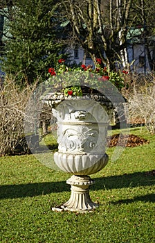 Decorative stone flowerpot with red flowers