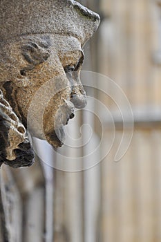Decorative stone head carving on wall of Bodleian library courtyard, Oxford, United Kingdom