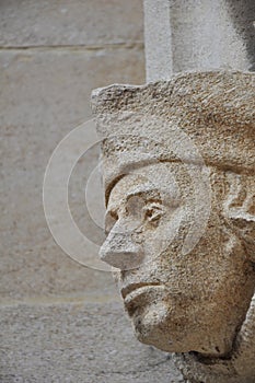Decorative stone head carving on wall of Bodleian library courtyard, Oxford, United Kingdom