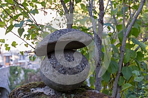 Decorative stone mushrooms appear at the bend of a path