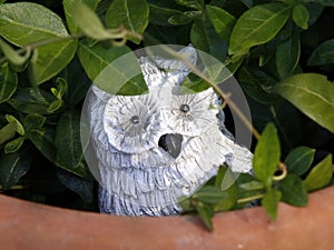 A decorative stone sculpture in a flower pot