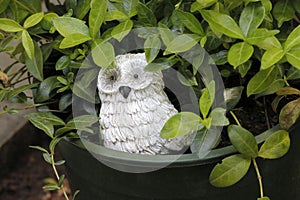 A decorative stone sculpture in a flower pot