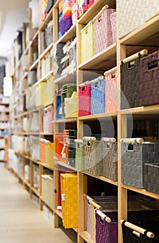 Decorative storage boxes on shelving in household goods store