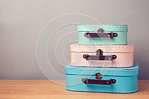 Decorative suitcase boxes on wooden table