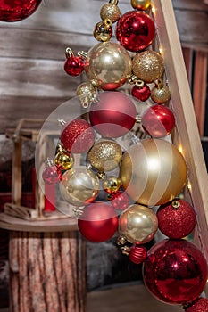 Decorative triangular Christmas tree of boards with balls. Christmas festive decorations