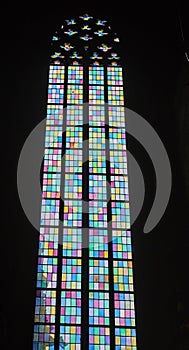 Decorative vaulted window made of multicolored rectangles.