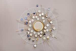 Decorative wall round mirror in the shape of the sun, a golden cooper mirror, modern shape in the Scandinavian style