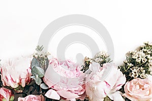 Decorative web banner made of beautiful pink peonies, rosies and eucalyptus isolated on white background. Feminine