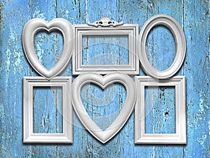 Decorative white photo frames on a blue wooden background