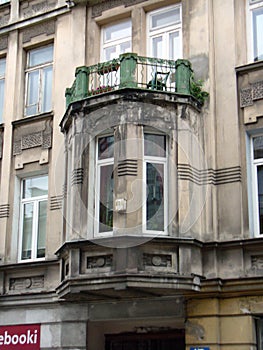 Decorative window building on grey wall with balcony