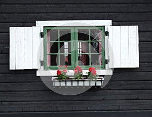 Decorative window of wooden cabin
