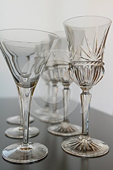 Decorative wine and martini glasses are set up in verticle rows displaying beautiful details of the glass