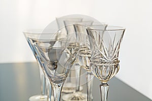 Decorative wine and martini glasses are set up in verticle rows displaying beautiful details of the glass